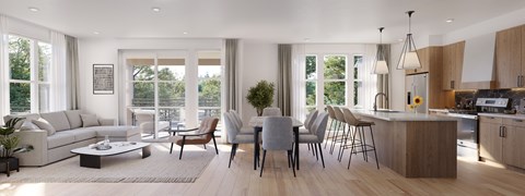 A modern kitchen and living room with a dining table set up.