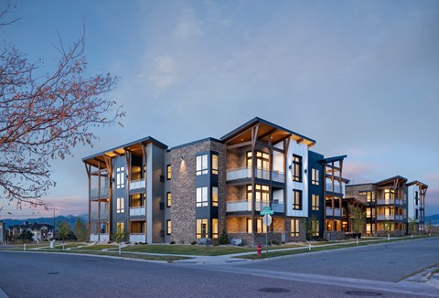 a rendering of an apartment building on a city street
