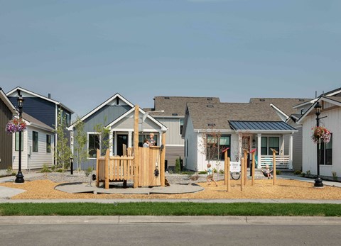 a playground in front of a group of homes