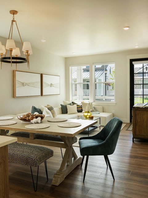 a dining room and living room with a table and chairs