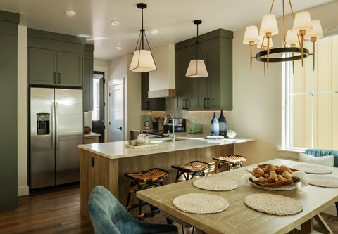 A kitchen with a table set for a meal.