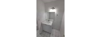 A white sink in a small bathroom.