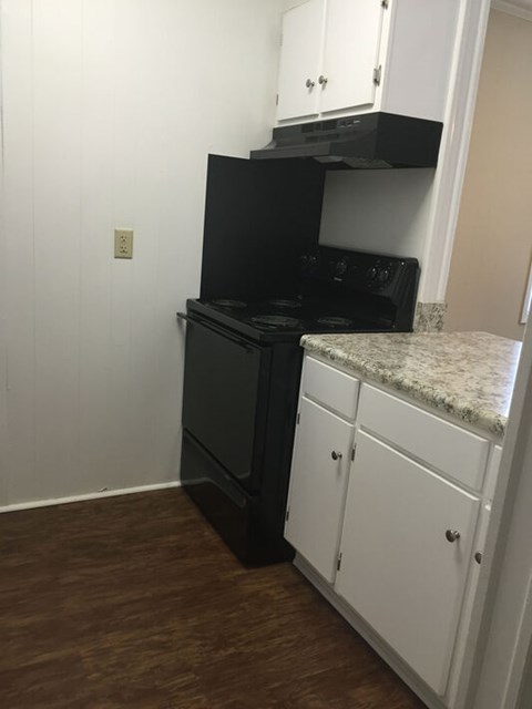 A black oven and stove top are on a kitchen island.
