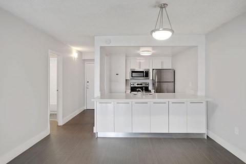 A kitchen with white cabinets and stainless steel appliances.