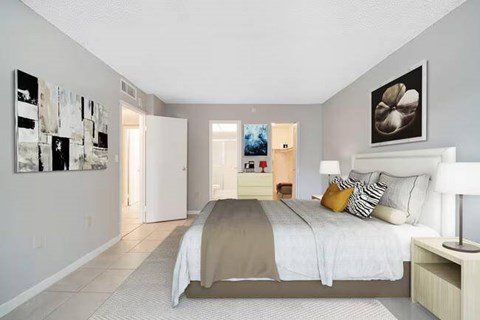 A bedroom with a large bed and a painting on the wall.