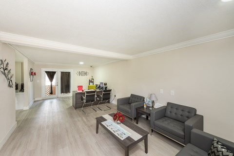 A living room with grey couches and a wooden coffee table.