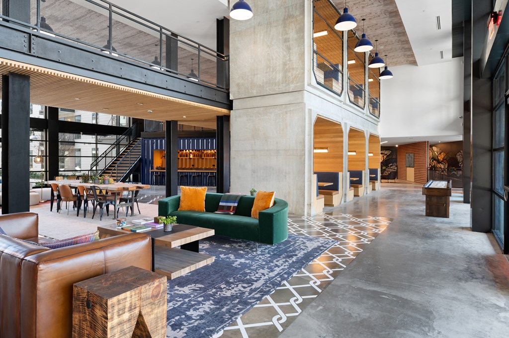 the lobby of a condo building with a lobby area with couches and chairs