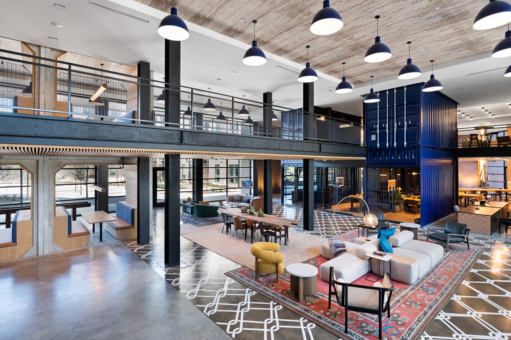 the lobby of a hotel with couches and tables