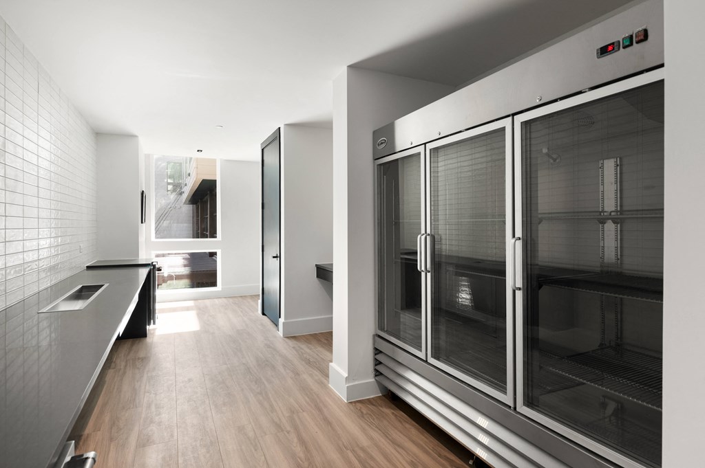 a kitchen with stainless steel appliances and a large glass refrigerator