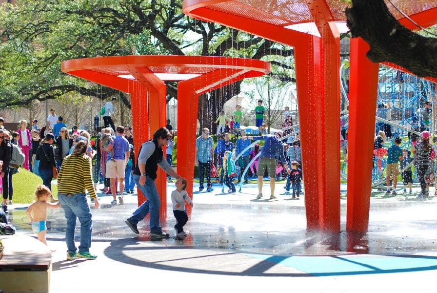 a crowd of people playing in a water park