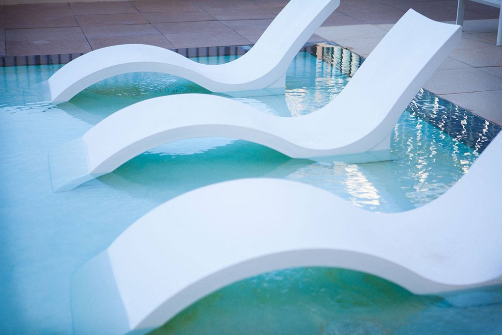 a pair of white plastic slides in a swimming pool