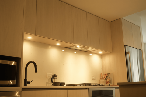 A kitchen with a stove and a microwave.