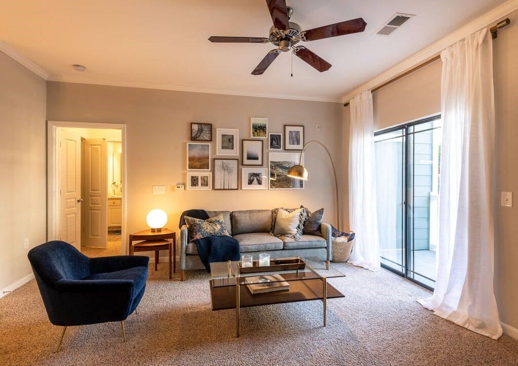 a living room with a couch and a ceiling fan