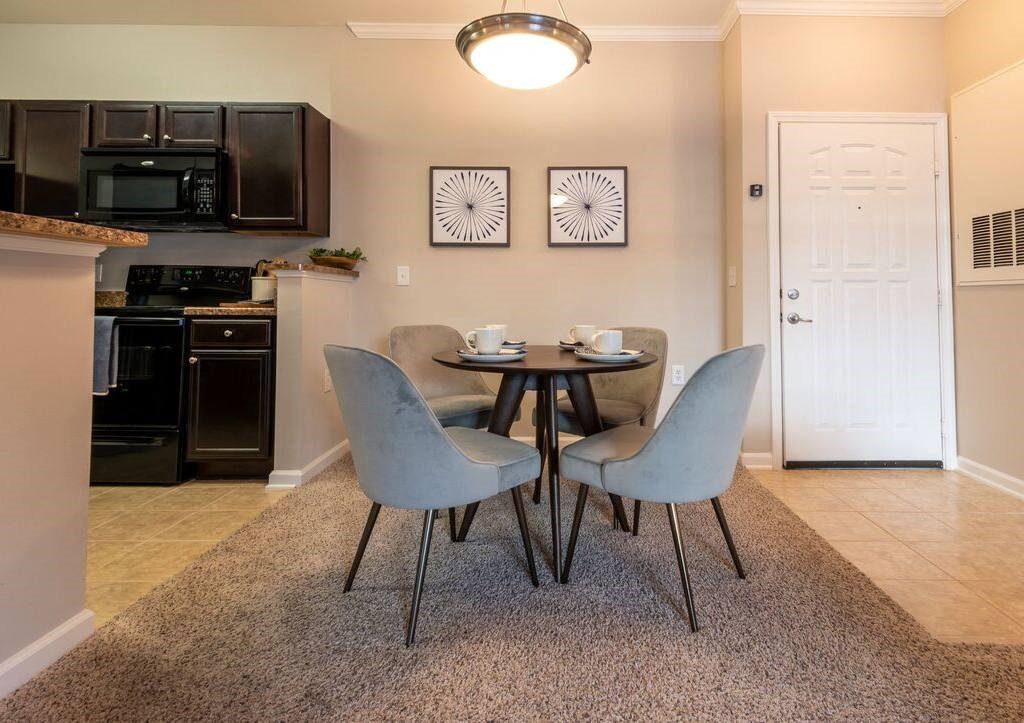 a dining room with a table and chairs and a kitchen
