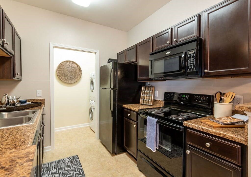 a kitchen with black appliances and granite counter tops