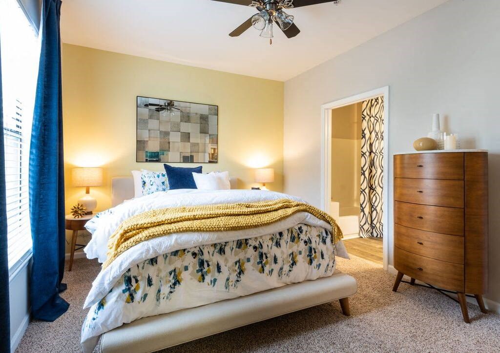 a bedroom with a bed and a ceiling fan