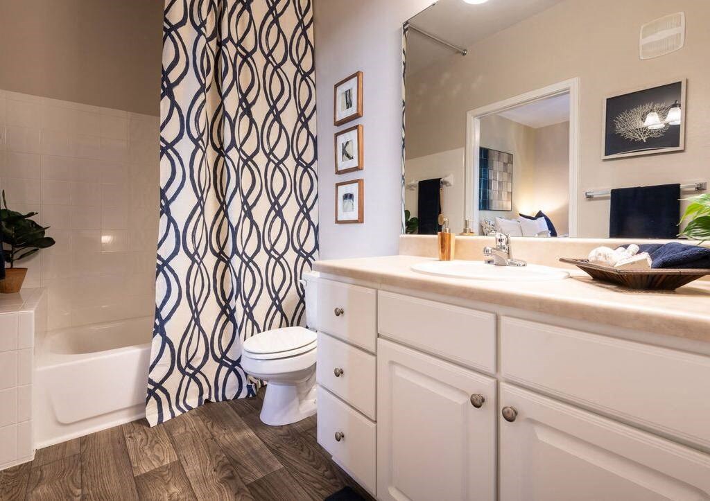 a bathroom with a toilet and a shower and a sink