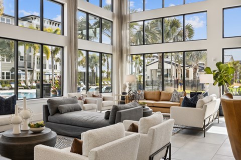 A large room with a lot of windows and furniture.