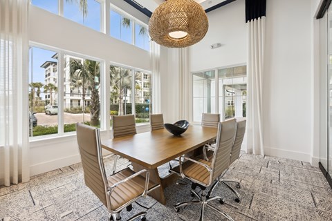 A conference room with a large table and chairs.