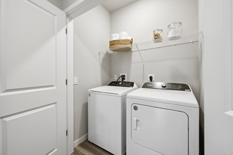 A white laundry room with a washer and dryer.
