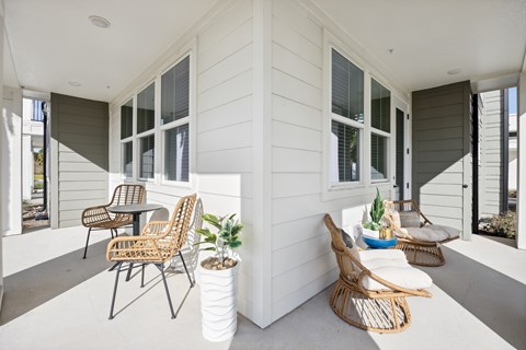 A patio with a table and chairs.