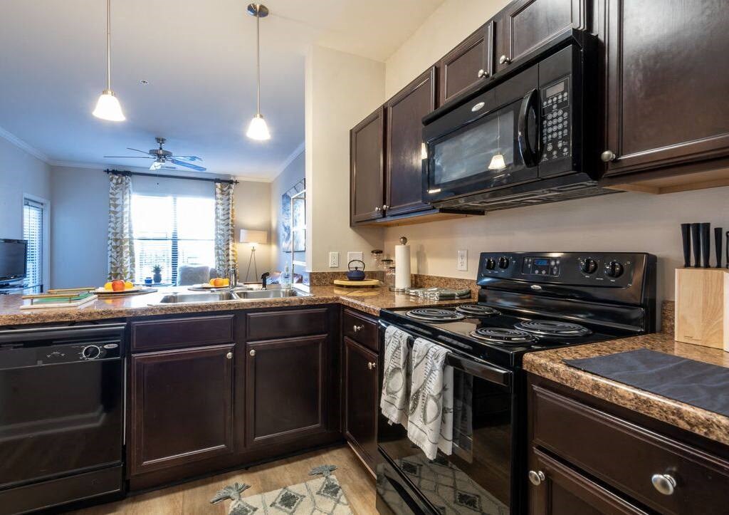 a kitchen with a stove microwave and a sink