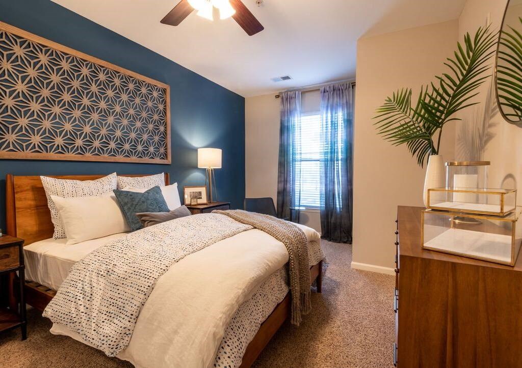 a bedroom with a bed and a plant