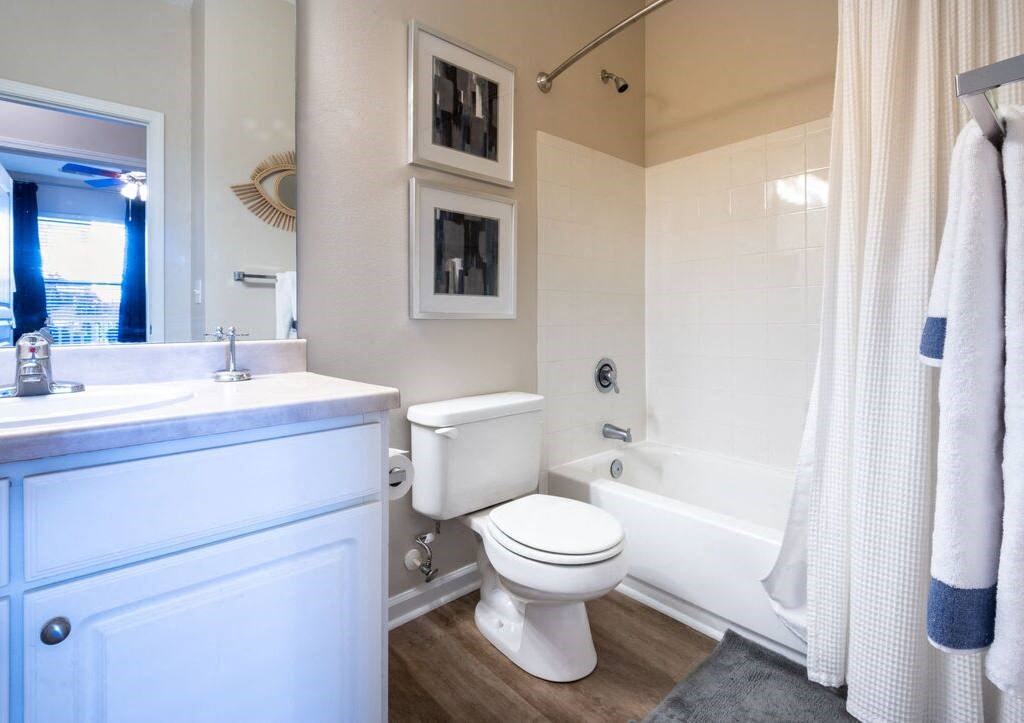 a bathroom with a toilet and a tub and a sink