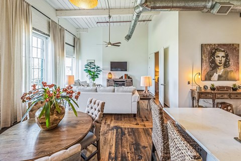 A living room with a white couch and a wooden table.