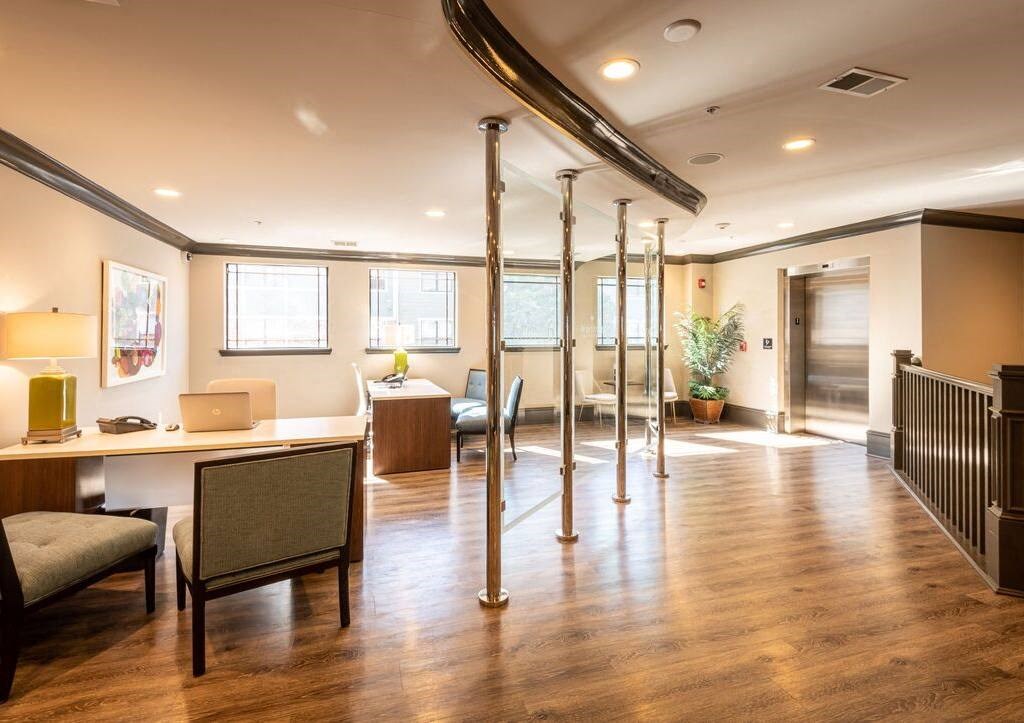 a conference room with desks and chairs and a table