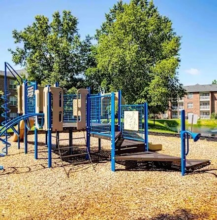 A playground with a slide, swings, and a climbing frame.