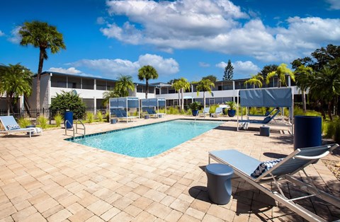 a resort style swimming pool in front of a building