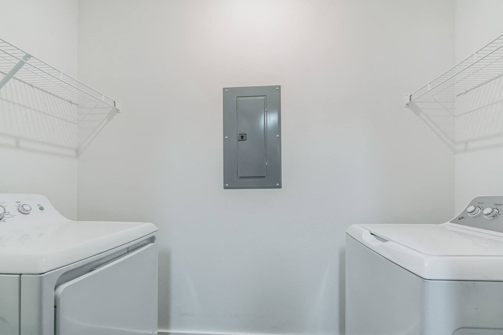a laundry room with two washes and a dryer