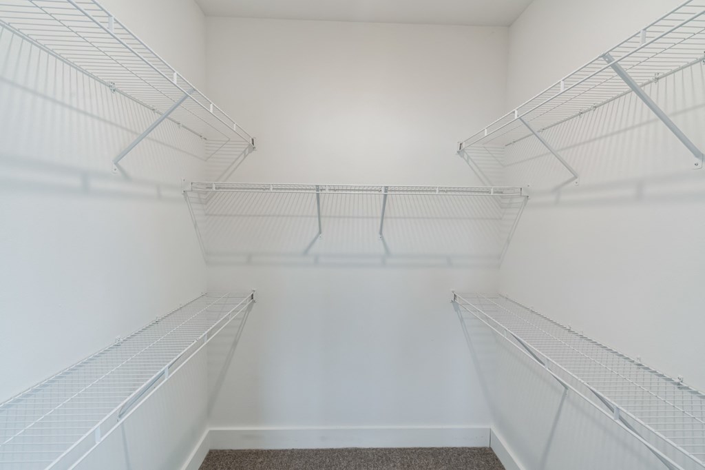 the walk in closet at the whispering winds apartments in pearland tx
