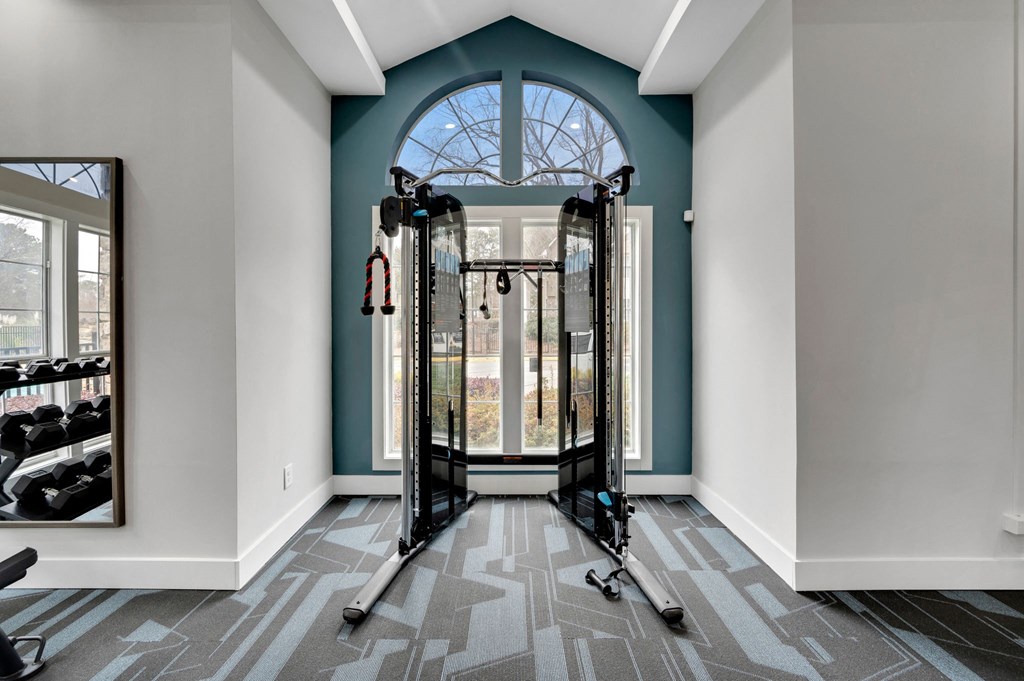 a fitness room with a large window and exercise equipment