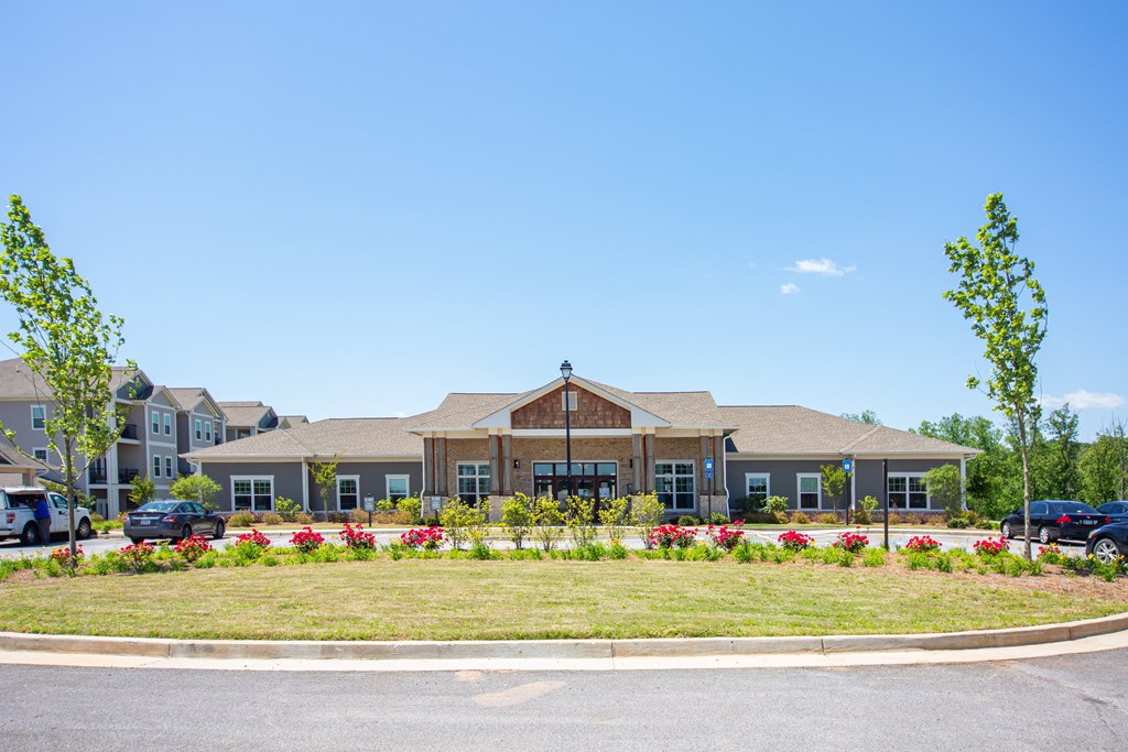 the front of a building with cars parked in front of it
