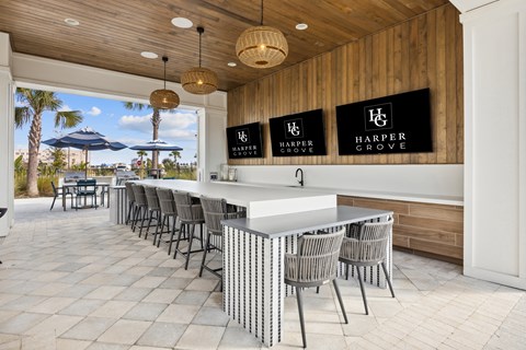 A Harper Grove sign is displayed on a wall above a bar.