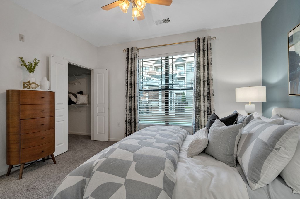 a bedroom with a large bed and a window