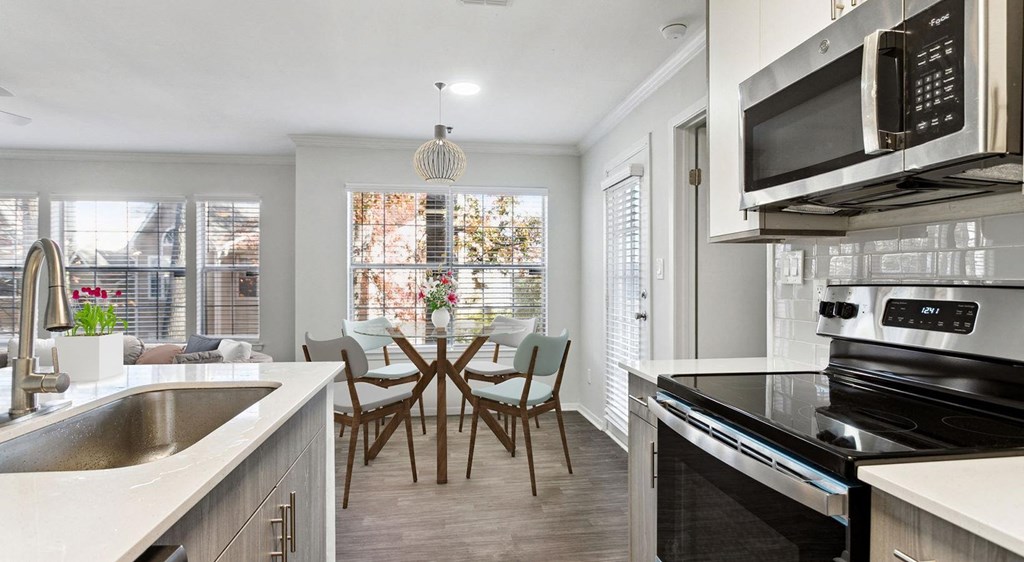 a kitchen and dining room with a table and chairs