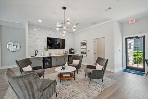 a living room with a kitchen and a table with chairs