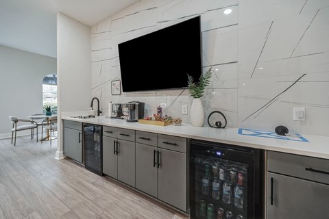 a kitchen with a counter and a tv on the wall