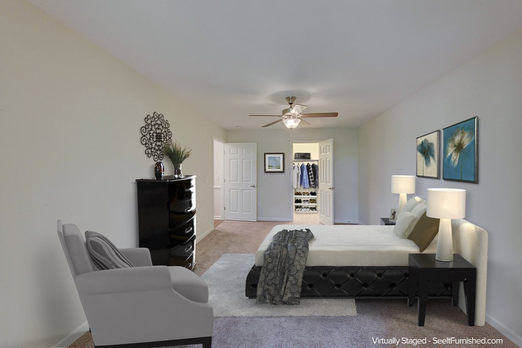 a bedroom with a large bed and a ceiling fan