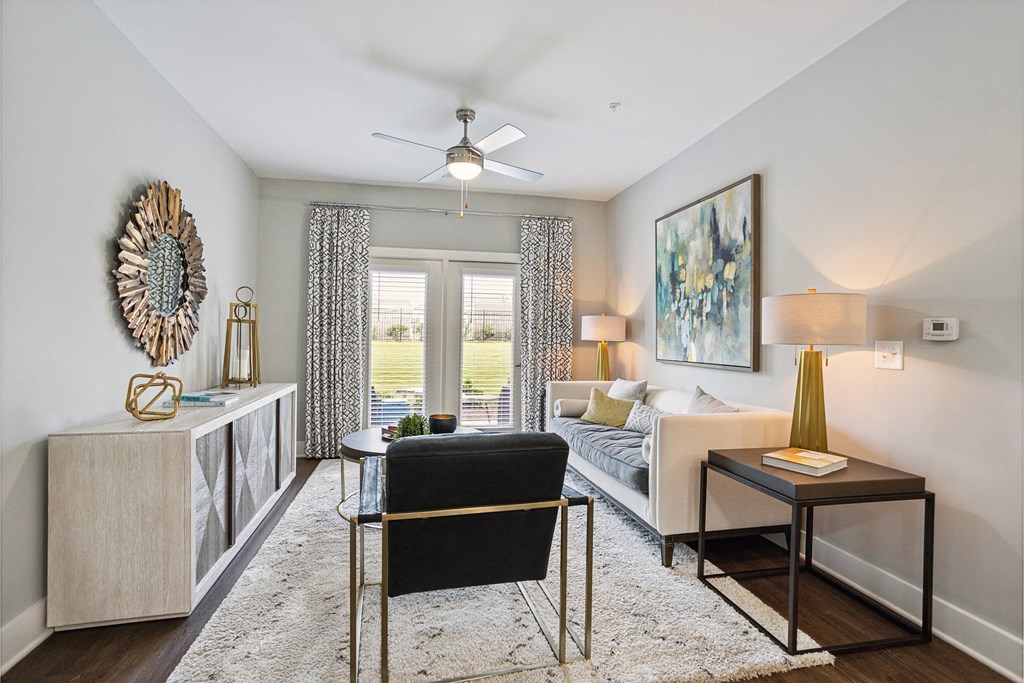 a living room with a couch and a ceiling fan