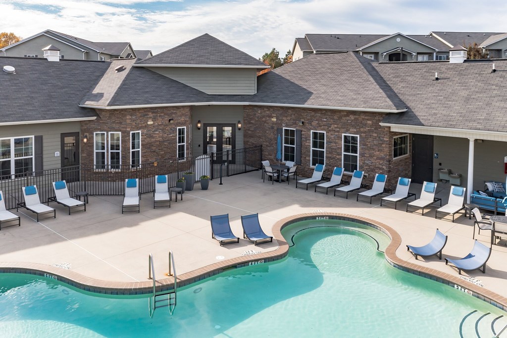 A pool with a building behind it.