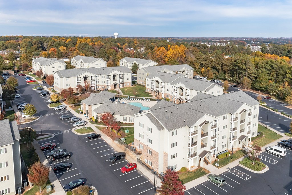 A parking lot in front of apartment buildings.