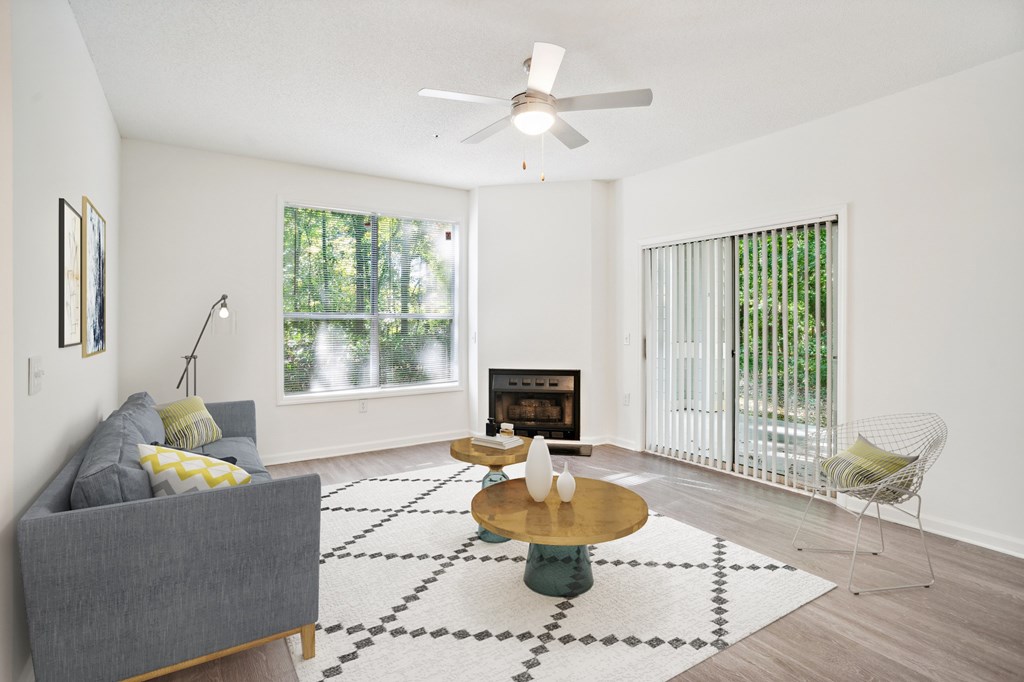 A living room with a grey couch, a coffee table, and a fireplace.