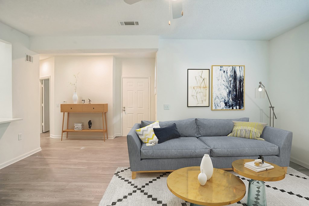A living room with a grey couch and a coffee table.