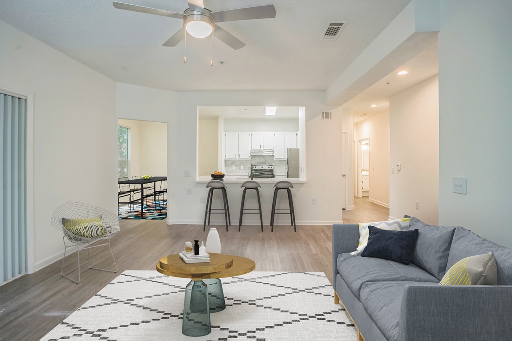 A living room with a grey couch and a coffee table.