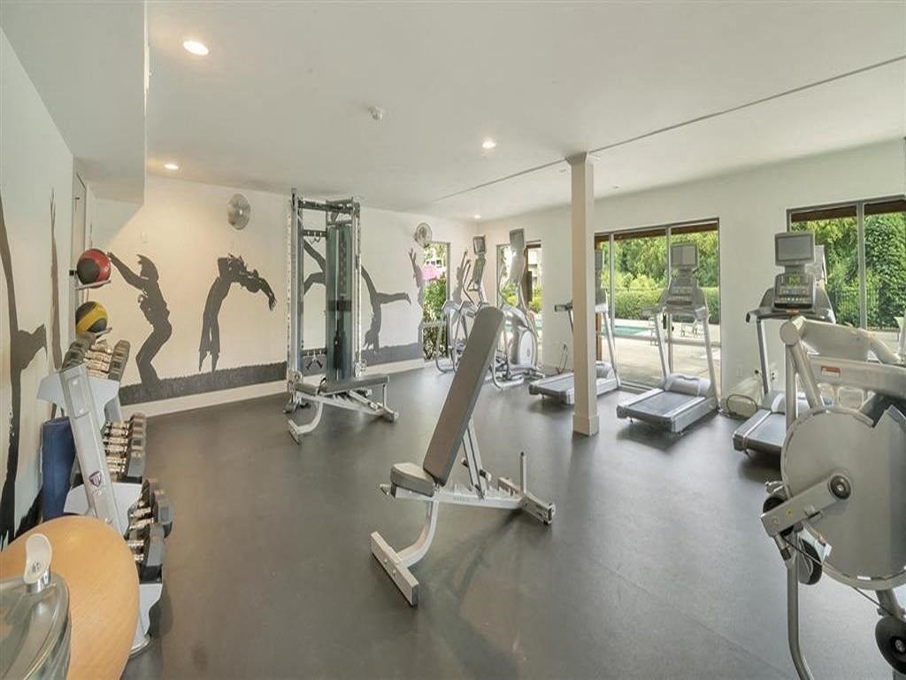 a gym with weights and cardio equipment on the floor