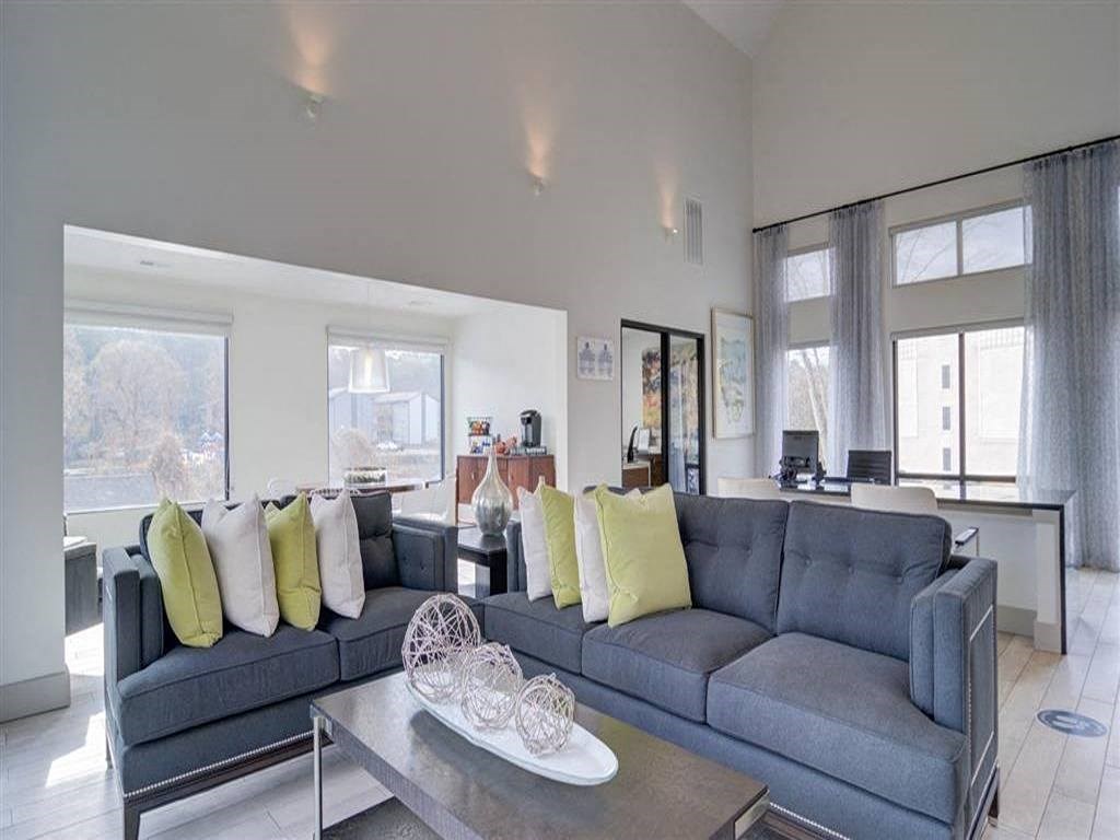 a living room with a blue couch and a glass table